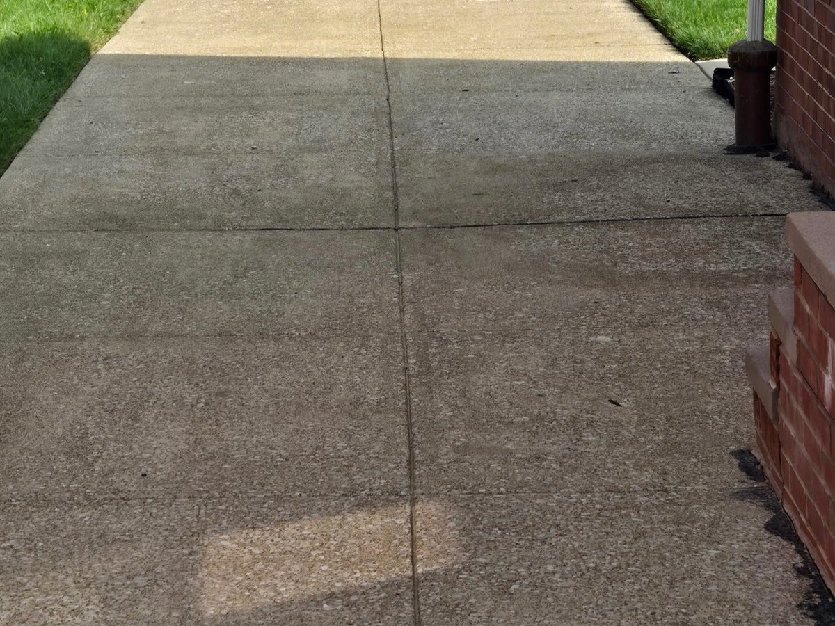 The same roughly 70-year-old residential concrete driveway after cleaning