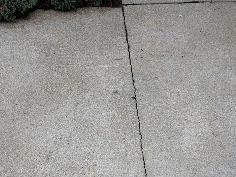 The same residential concrete area after targeted rust treatment with the orange staining removed